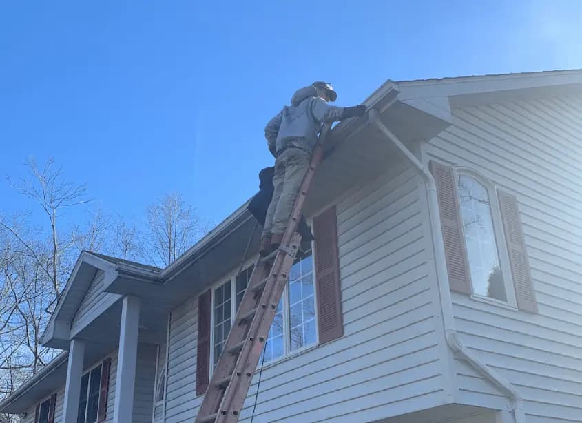 Gutter cleaning and maintenance being performed by Eastlake Power Washing in Eastlake